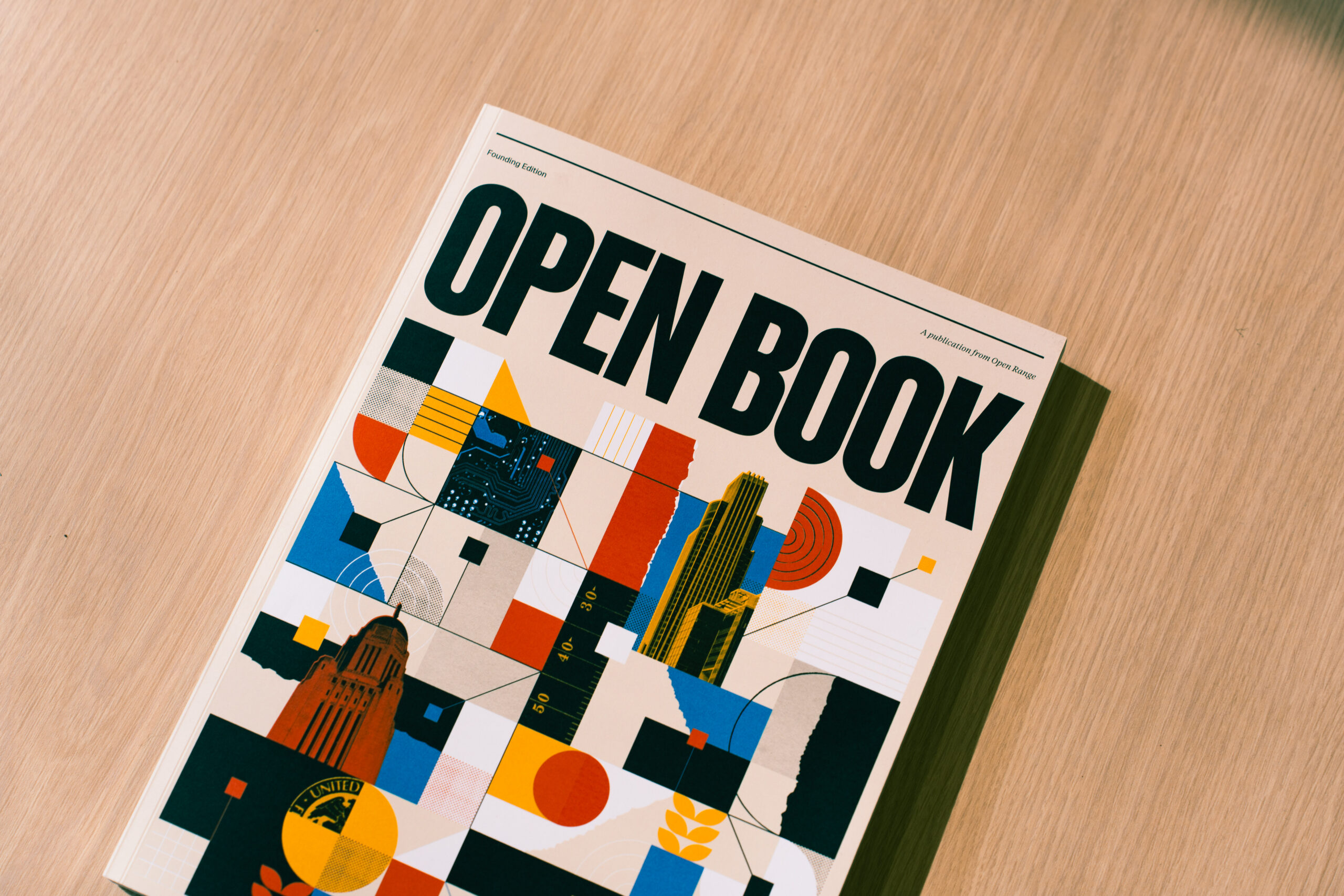 The Open Book founding edition on a wooden table